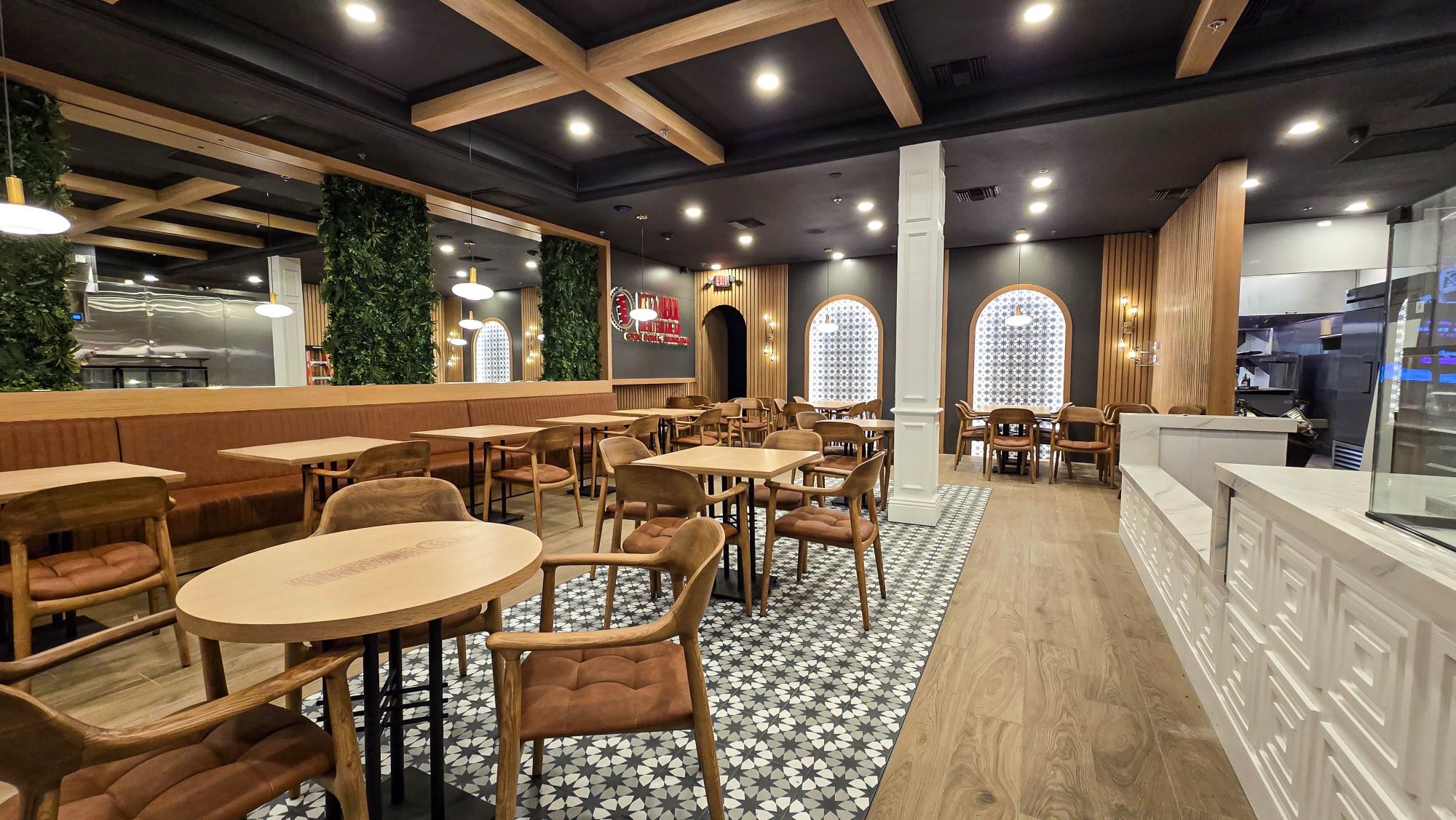 Restaurant interior with custom banquettes, wood ceiling beams and service counter